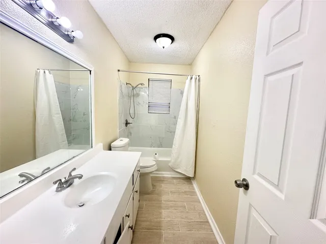 a bathroom with a shower sink vanity and mirror