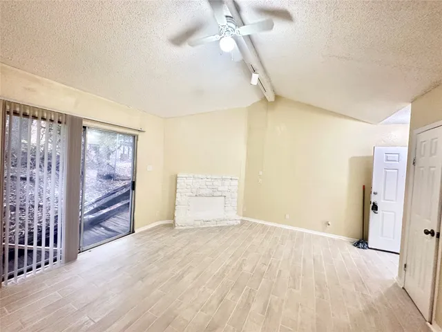 a kitchen with granite countertop cabinets appliances and a wooden floor