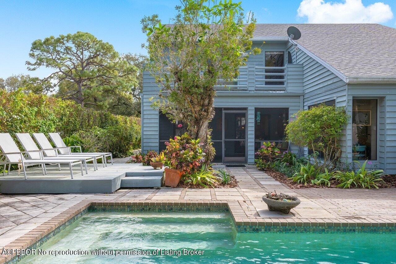 a view of a house with backyard and sitting area