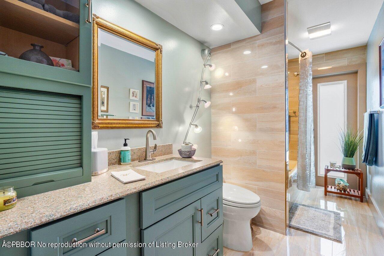 1111 Southwest 19th Street Boca Raton, FL 33486 - Photo 13 of 37 a bathroom with a granite countertop sink toilet a mirror and shower