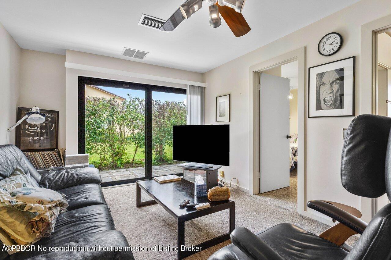 1111 Southwest 19th Street Boca Raton, FL 33486 - Photo 15 of 37 a living room with furniture and a flat screen tv