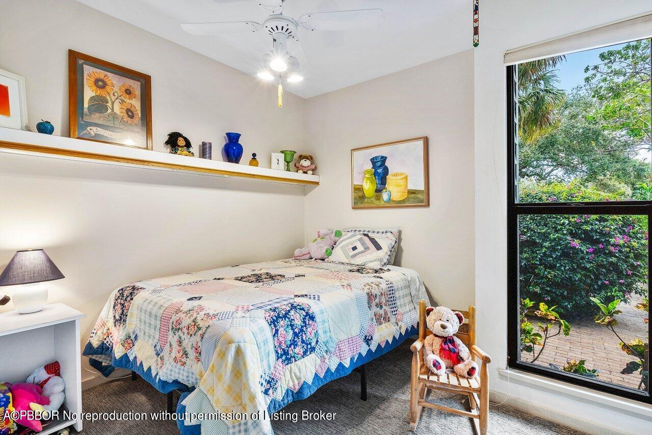 1111 Southwest 19th Street Boca Raton, FL 33486 - Photo 17 of 37 a bedroom with a bed a painting on the wall and a large window