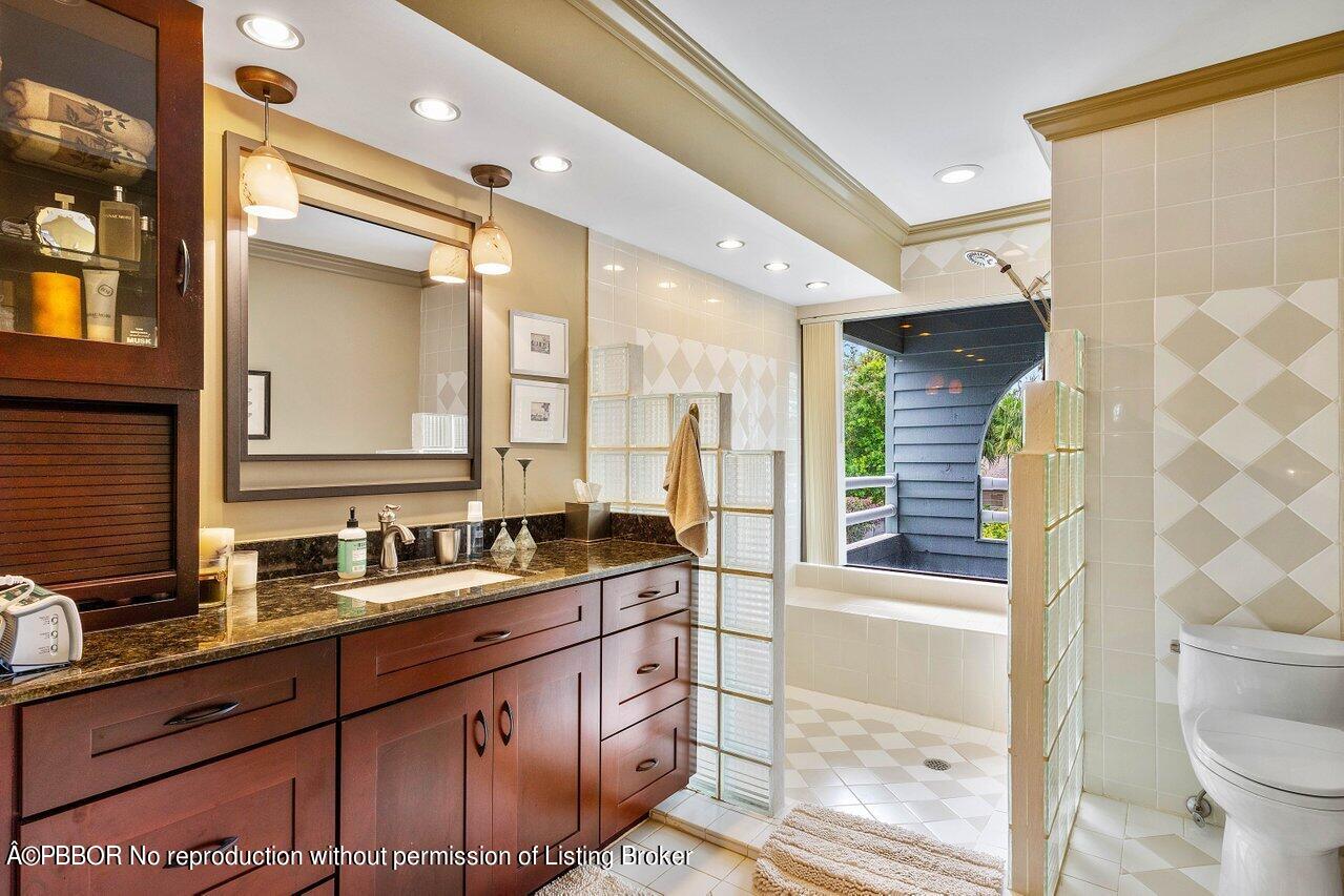 1111 Southwest 19th Street Boca Raton, FL 33486 - Photo 22 of 37 a bathroom with a double vanity sink toilet and shower