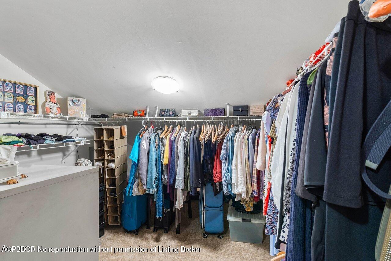 1111 Southwest 19th Street Boca Raton, FL 33486 - Photo 24 of 37 a view of walk in closet with clothes and shoes