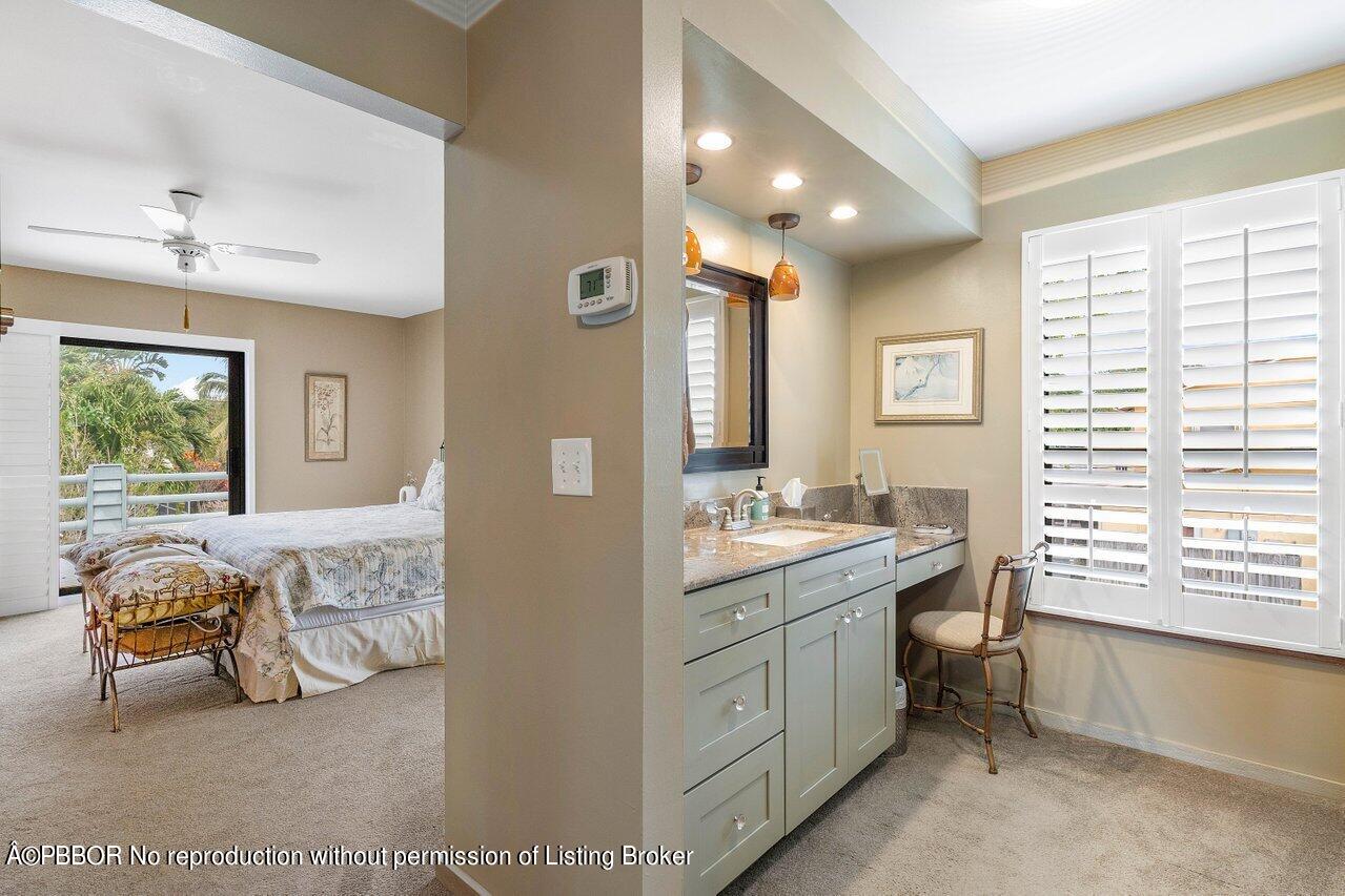 1111 Southwest 19th Street Boca Raton, FL 33486 - Photo 25 of 37 a en suite bathroom with a double vanity sink a mirror and a bathtub
