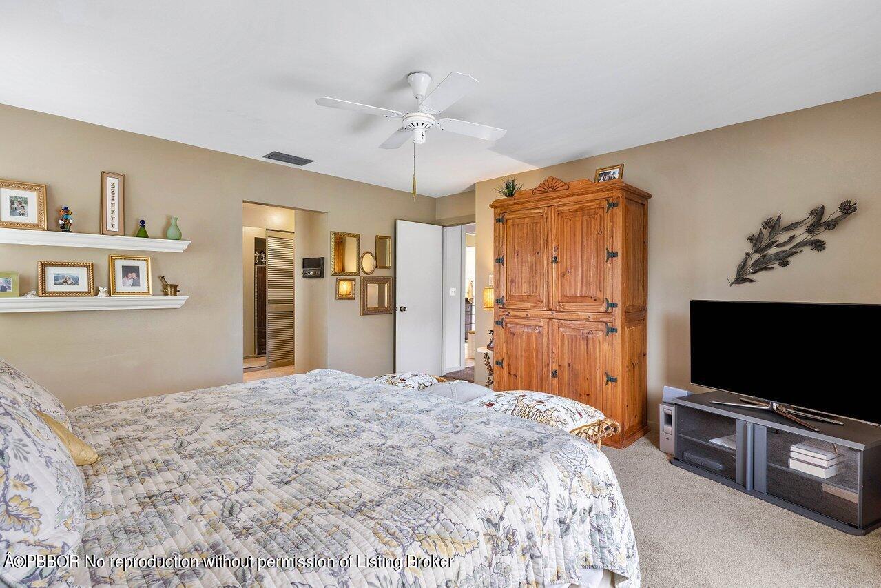 1111 Southwest 19th Street Boca Raton, FL 33486 - Photo 27 of 37 a bedroom with a bed and a flat screen tv