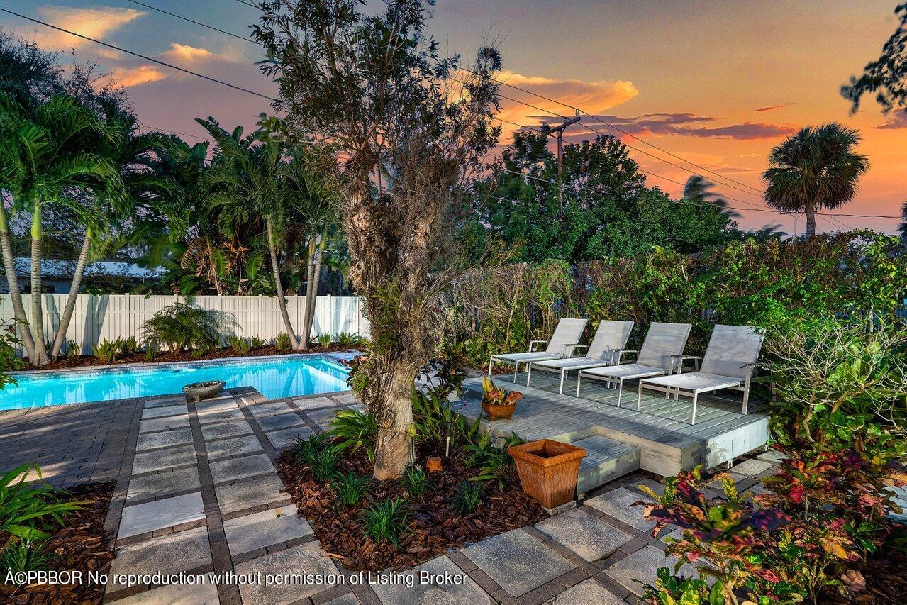 1111 Southwest 19th Street Boca Raton, FL 33486 - Photo 36 of 37 a wooden bench sitting in front of a house