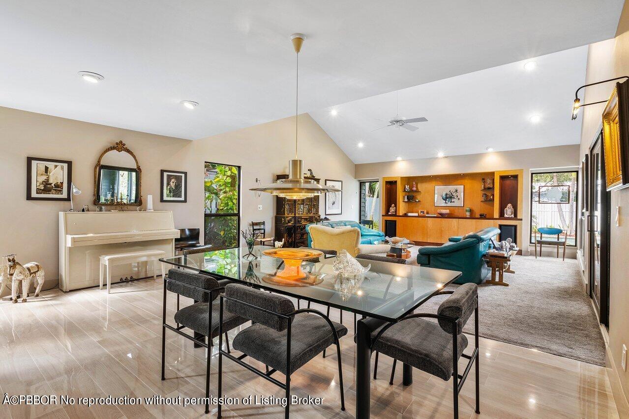 1111 Southwest 19th Street Boca Raton, FL 33486 - Photo 7 of 37 a view of a dining room and livingroom with furniture wooden floor a rug a flat screen tv