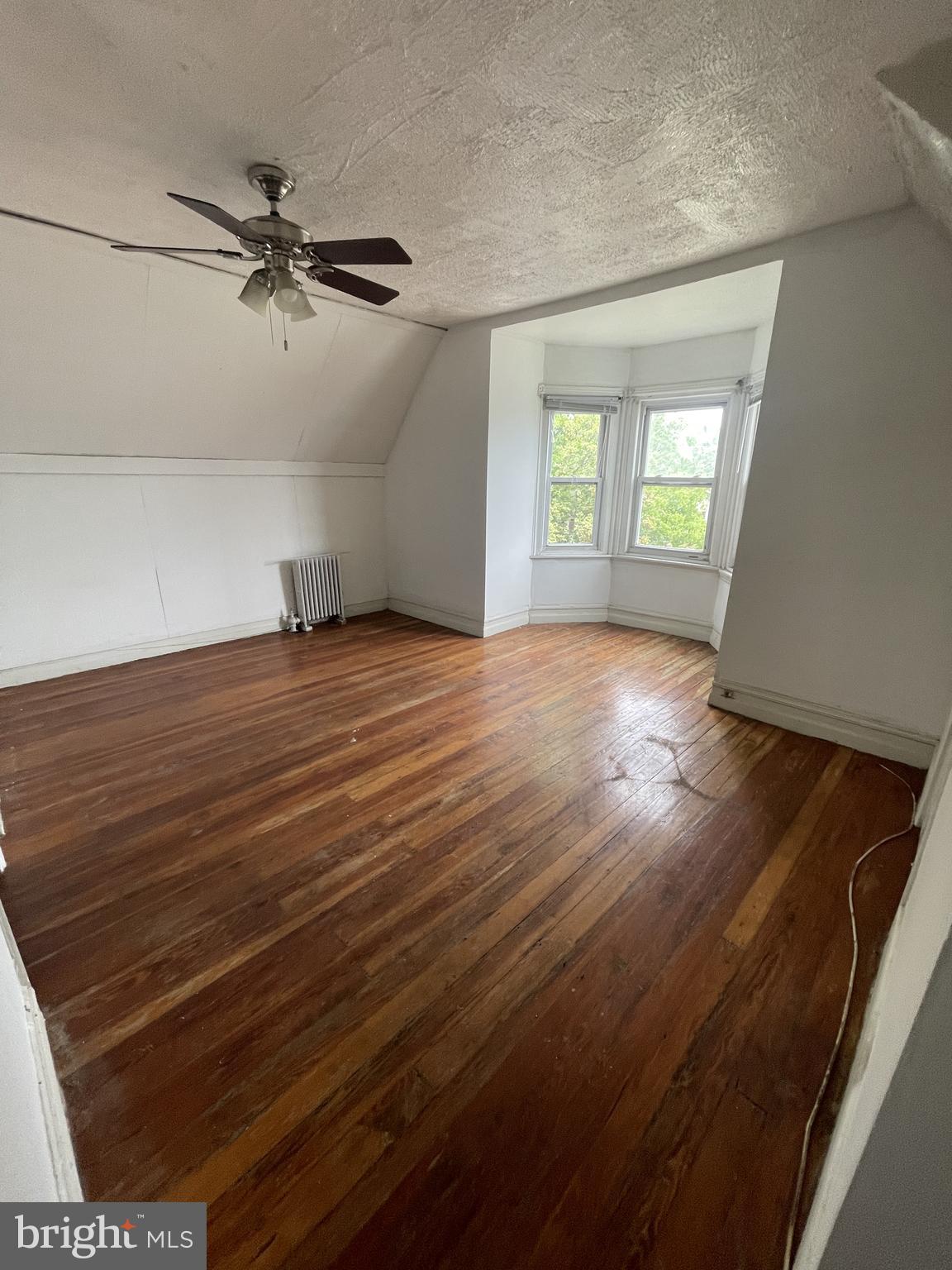 840 North 63rd Street Philadelphia, PA 19151 - Photo 4 of 7 an empty room with wooden floor fan and windows