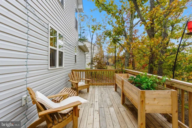 a view of balcony with wooden floor and outdoor seating