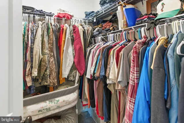 a view of walk in closet with clothes