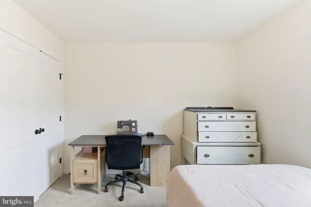 a bedroom with a bed and a chair