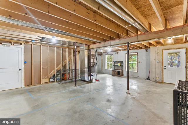 a view of empty room with wooden walls