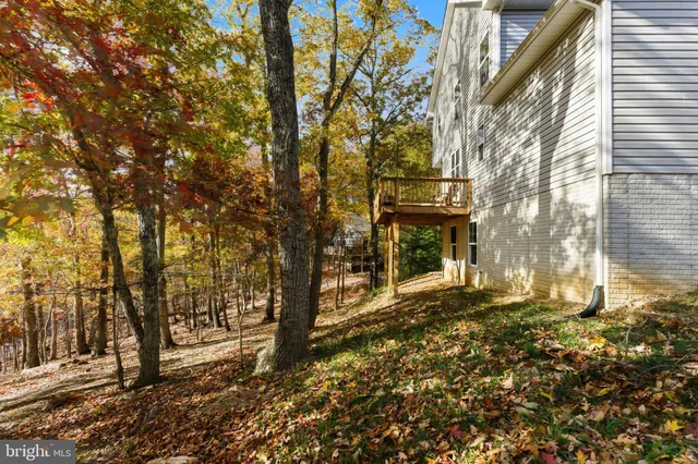 a front view of a house with a tree