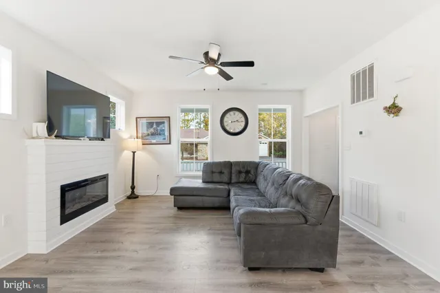 a living room with fireplace furniture and a flat screen tv