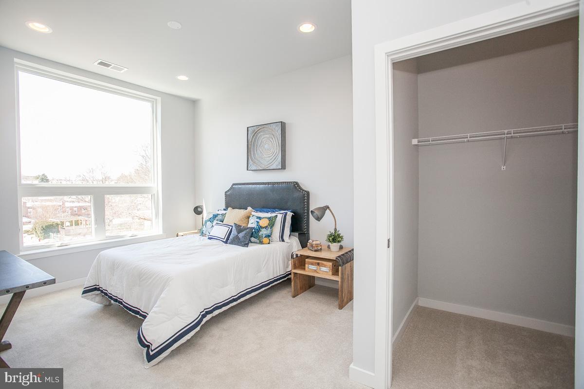 5938 Henry Avenue, Unit 12 Philadelphia, PA 19128 - Photo 15 of 19 a bedroom with a bed and a window