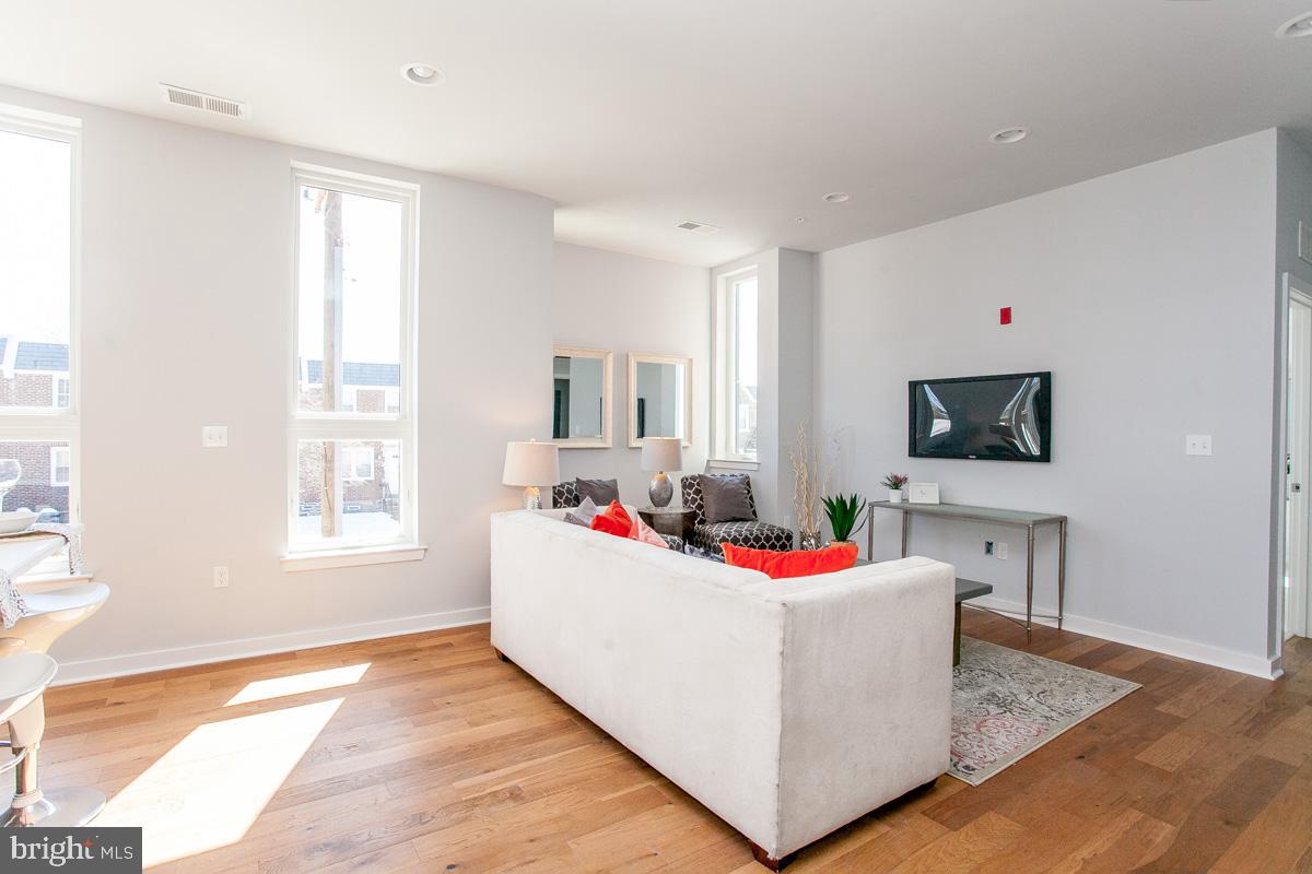 5938 Henry Avenue, Unit 12 Philadelphia, PA 19128 - Photo 4 of 19 a living room with dining room and flat screen tv
