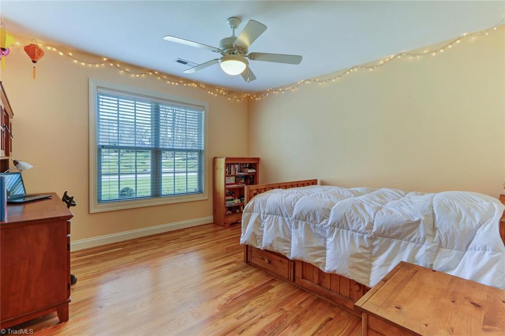 7085 Lanier Road Summerfield, NC 27358 - Photo 16 of 30 2nd bedroom. Wood floors & walk in closet