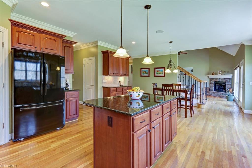 7085 Lanier Road Summerfield, NC 27358 - Photo 9 of 30 Kitchen island and granite countertops