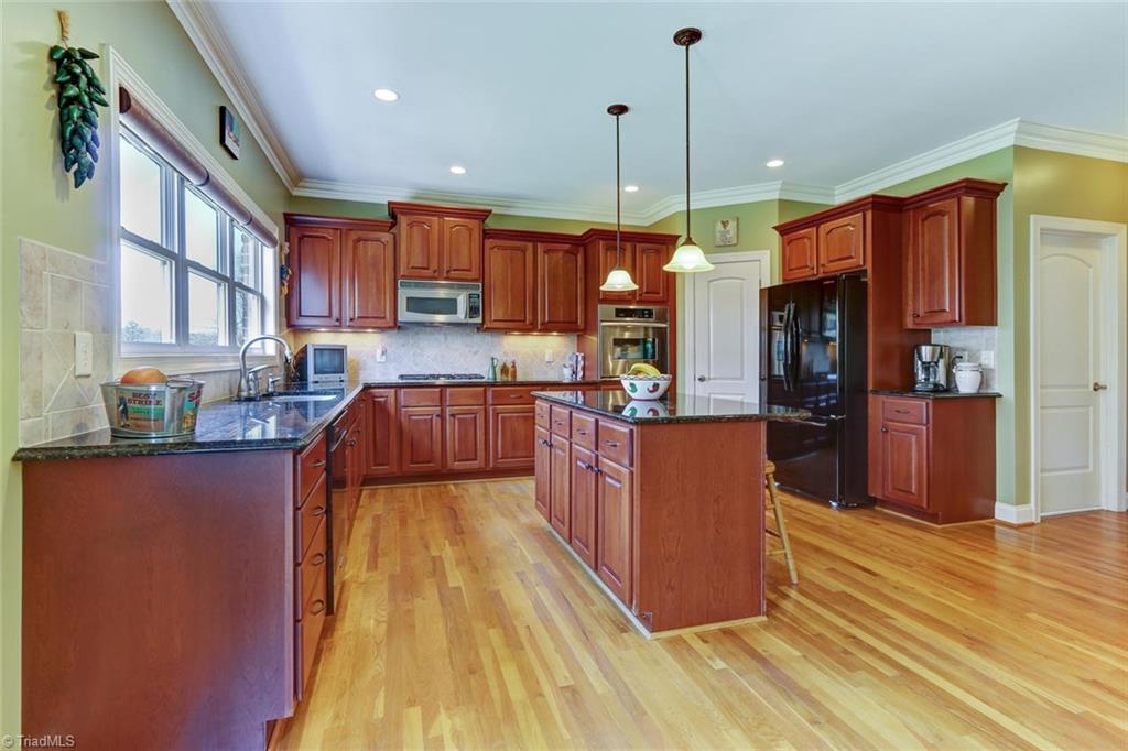 7085 Lanier Road Summerfield, NC 27358 - Photo 10 of 30 Spacious kitchen with views out to the lake