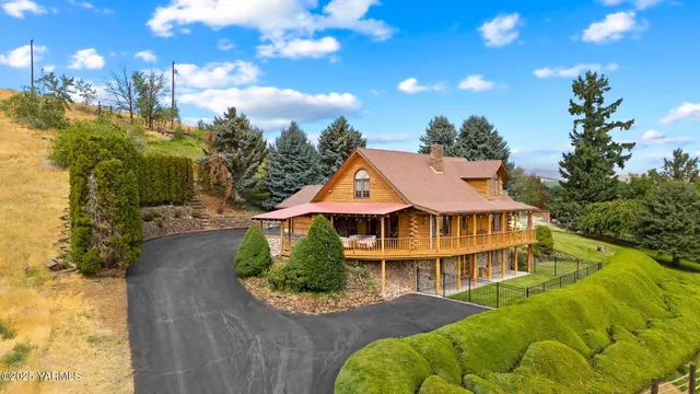 a front view of a house with a yard and fountain