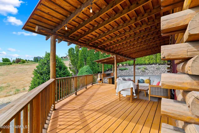 a living room with furniture a chandelier and a floor to ceiling window