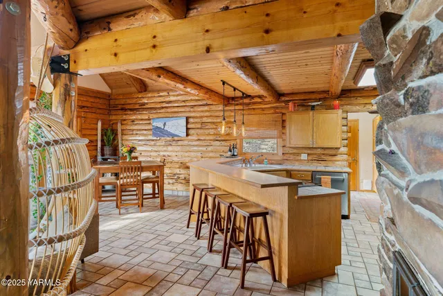 a roof deck with a dining table and chairs with an umbrella