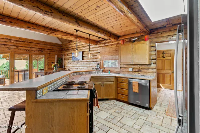 a open kitchen with stainless steel appliances granite countertop a sink a stove and cabinets