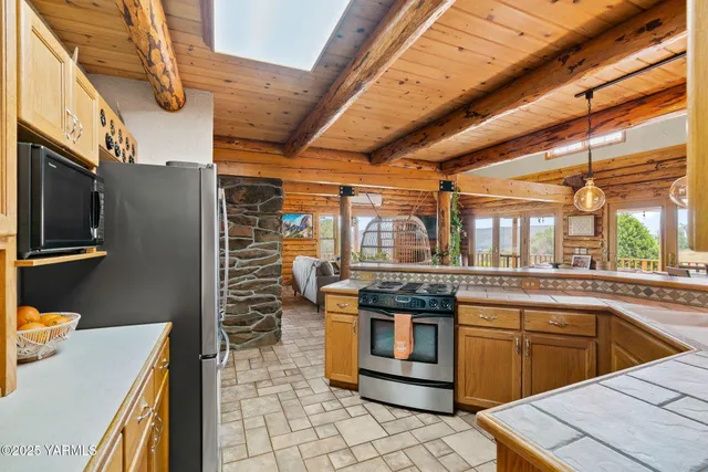 a kitchen with stainless steel appliances granite countertop a sink and cabinets