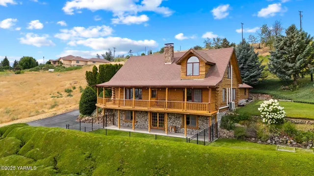 a view of a house with garden and a yard