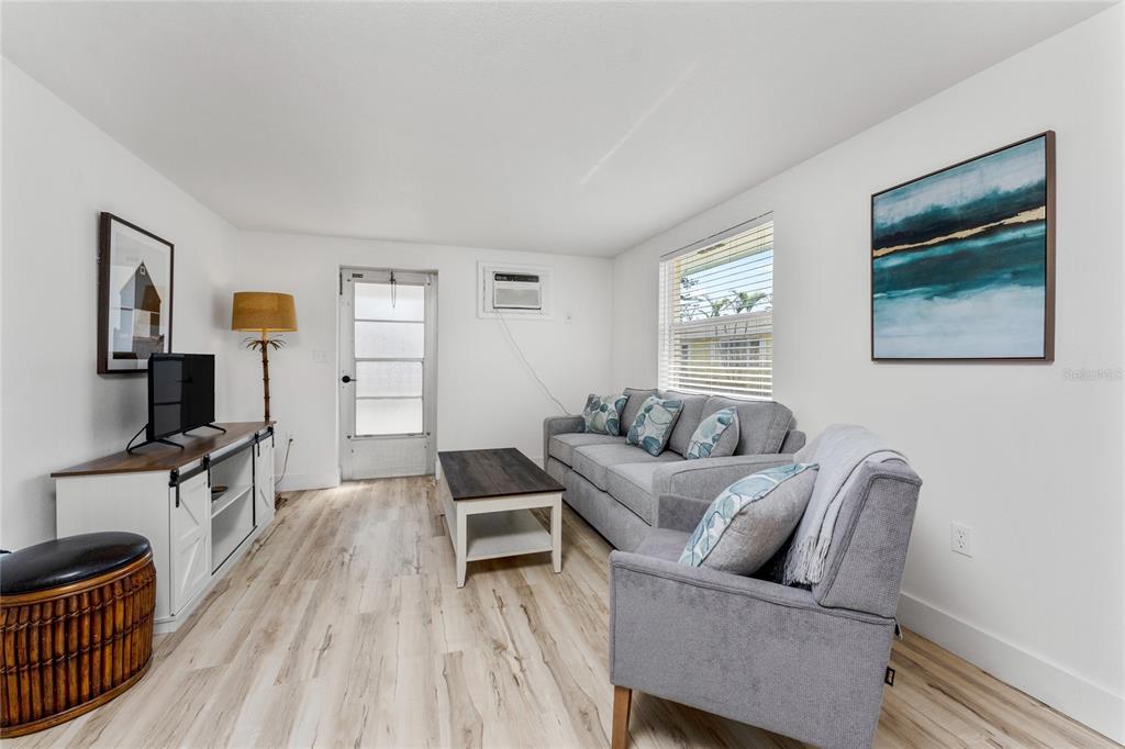 470 South McCall Road, Unit 10 Englewood, FL 34223 - Photo 12 of 57 a living room with furniture and a flat screen tv
