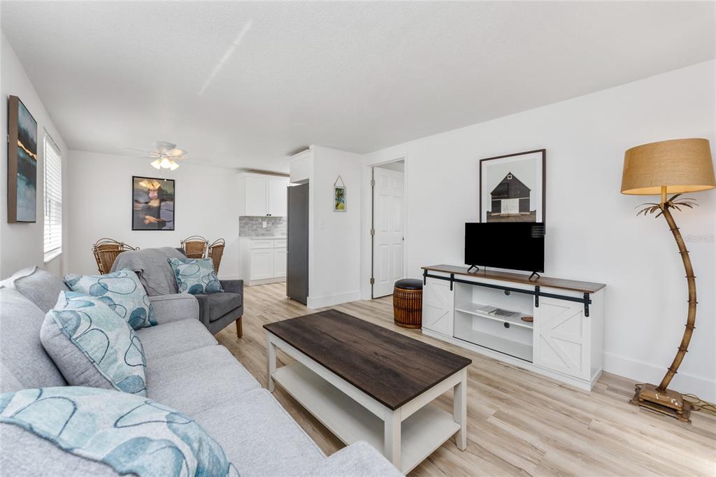 470 South McCall Road, Unit 10 Englewood, FL 34223 - Photo 13 of 57 a living room with furniture and a flat screen tv