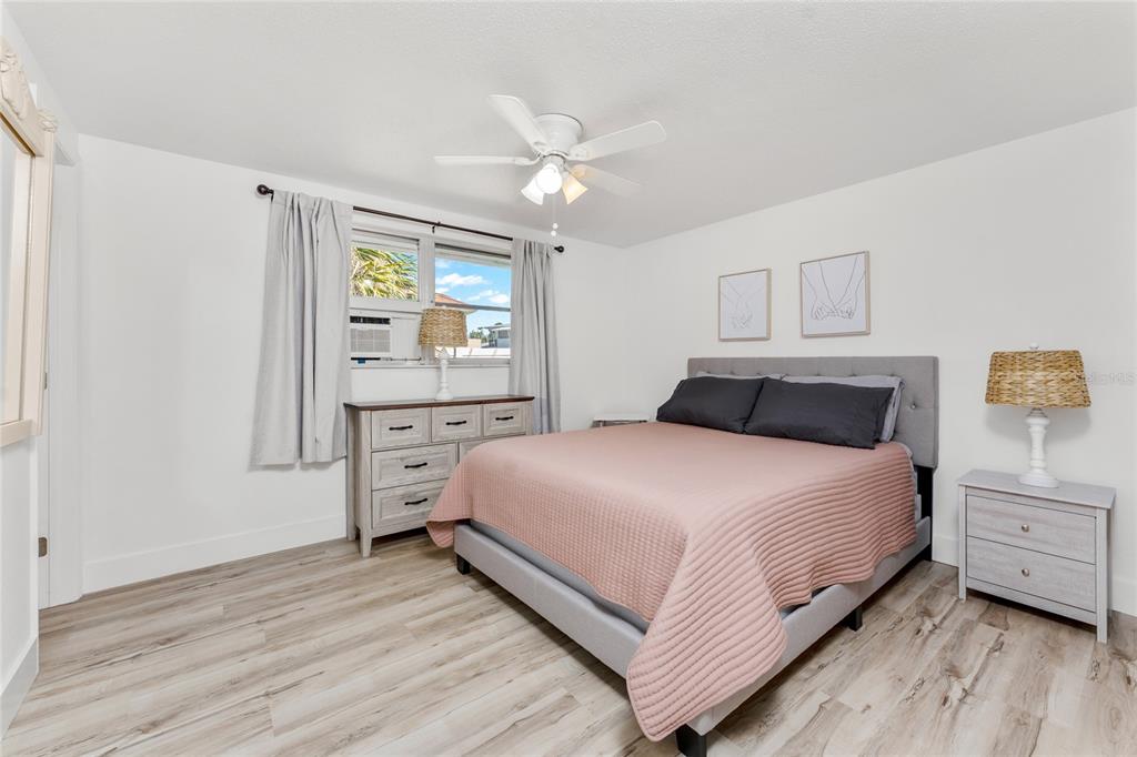 470 South McCall Road, Unit 10 Englewood, FL 34223 - Photo 20 of 57 a bedroom with a large bed and a window