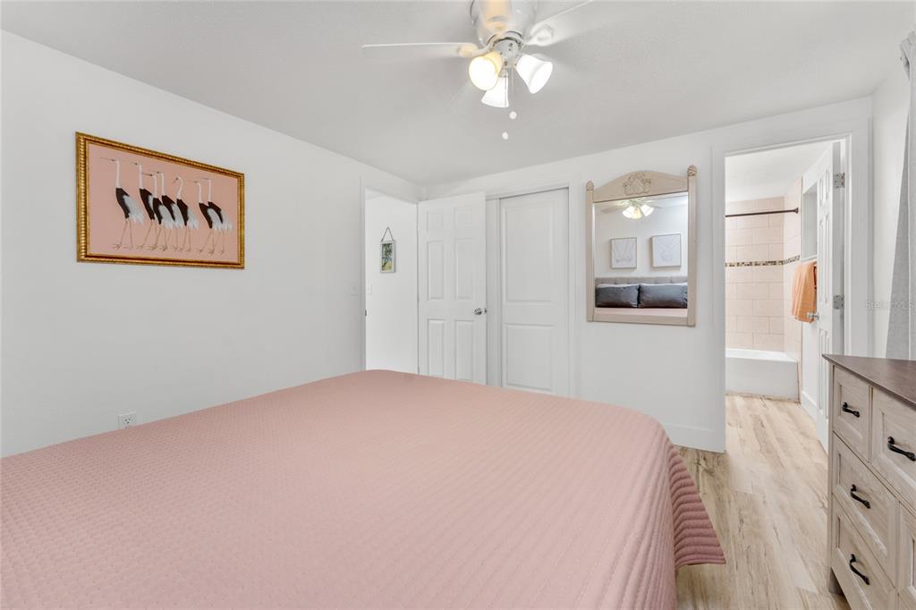 470 South McCall Road, Unit 10 Englewood, FL 34223 - Photo 22 of 57 a bedroom with a bed and a chandelier