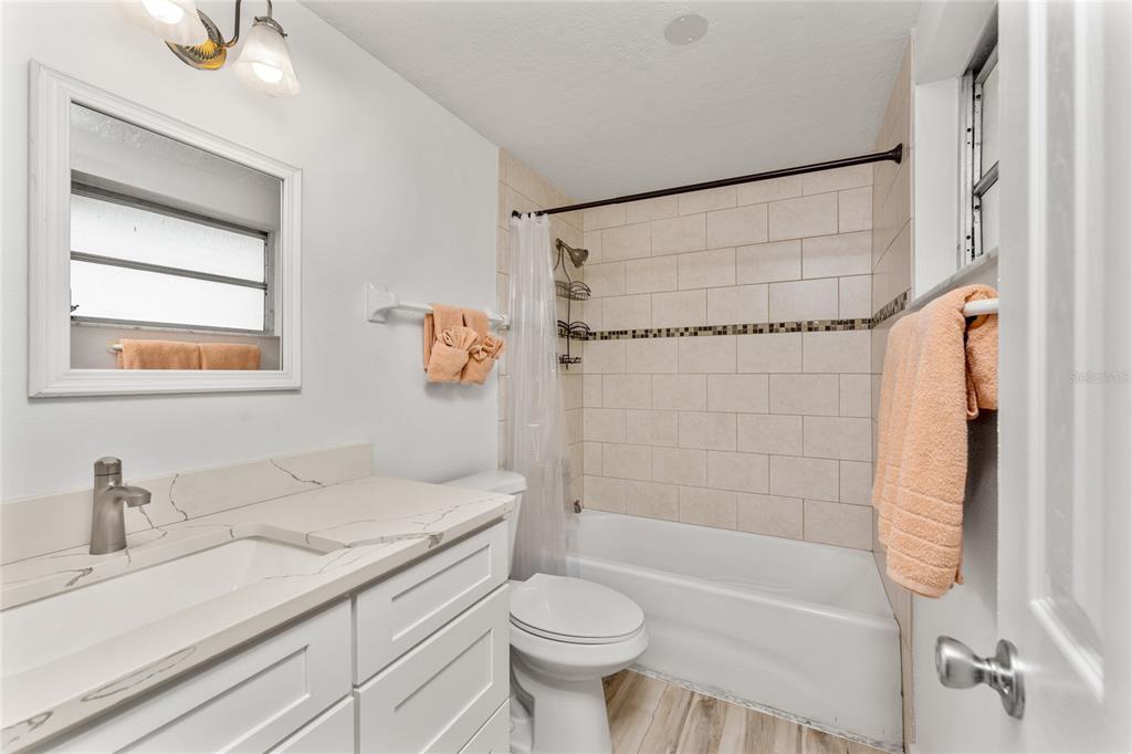 470 South McCall Road, Unit 10 Englewood, FL 34223 - Photo 23 of 57 a bathroom with a sink a toilet and shower