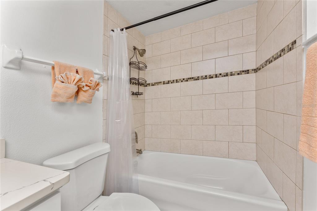 470 South McCall Road, Unit 10 Englewood, FL 34223 - Photo 24 of 57 a bath room with a toilet and a bath tub