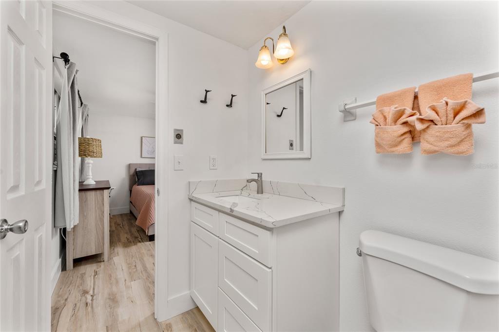 470 South McCall Road, Unit 10 Englewood, FL 34223 - Photo 25 of 57 a bathroom with a sink toilet and shower