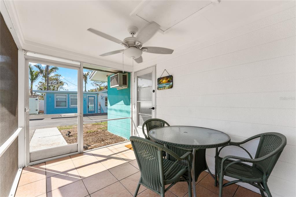470 South McCall Road, Unit 10 Englewood, FL 34223 - Photo 27 of 57 a view of a dining room with furniture wooden floor and a chandelier