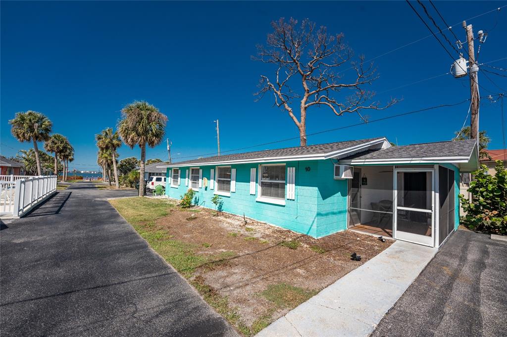 470 South McCall Road, Unit 10 Englewood, FL 34223 - Photo 28 of 57 a front view of a house with garden