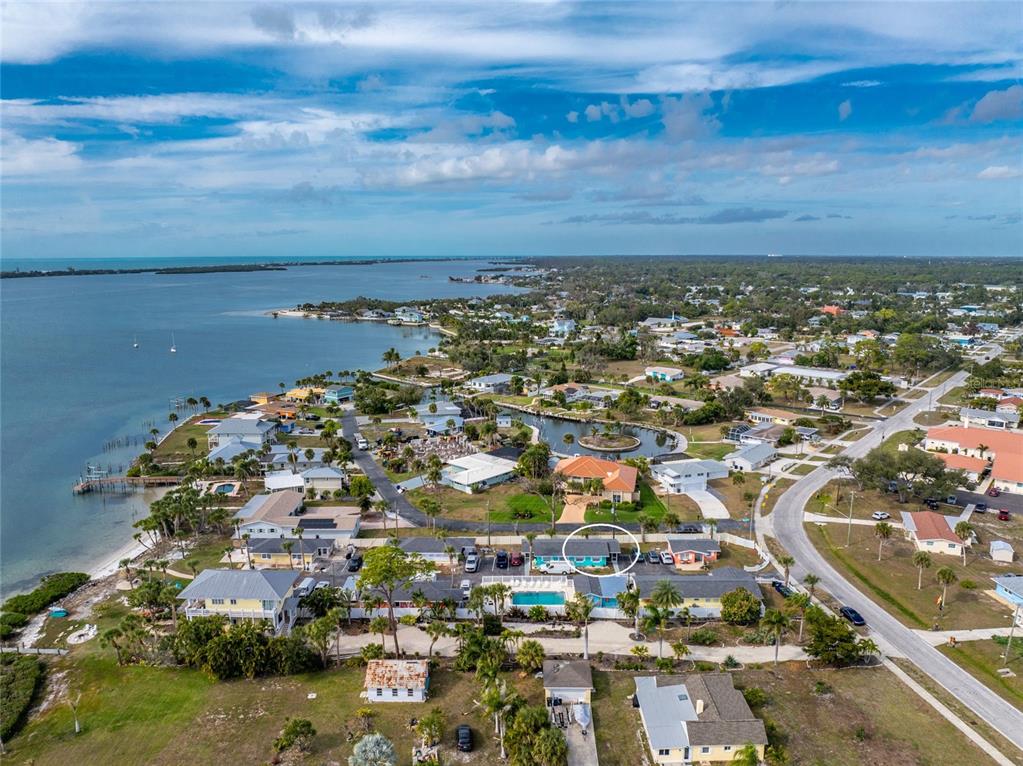 470 South McCall Road, Unit 10 Englewood, FL 34223 - Photo 47 of 57 an aerial view of a city with lots of residential buildings ocean and mountain view in back