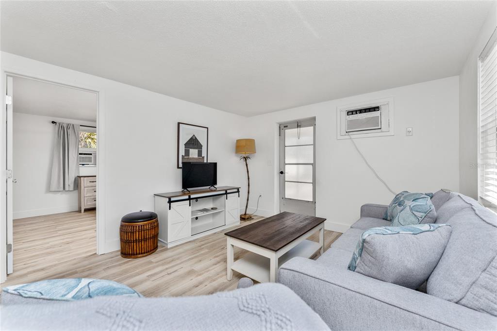 470 South McCall Road, Unit 10 Englewood, FL 34223 - Photo 10 of 57 a living room with furniture and a flat screen tv
