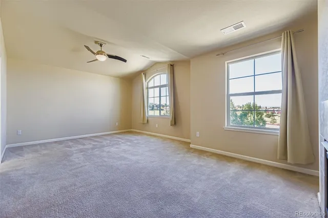 an empty room with windows and closet