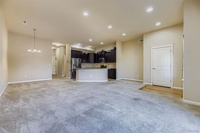 a view of a kitchen with a refrigerator and a stove