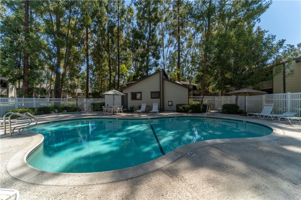 20702 El Toro Road, Unit 413 Lake Forest, CA 92630 - Photo 20 of 29 a swimming pool with outdoor seating and yard