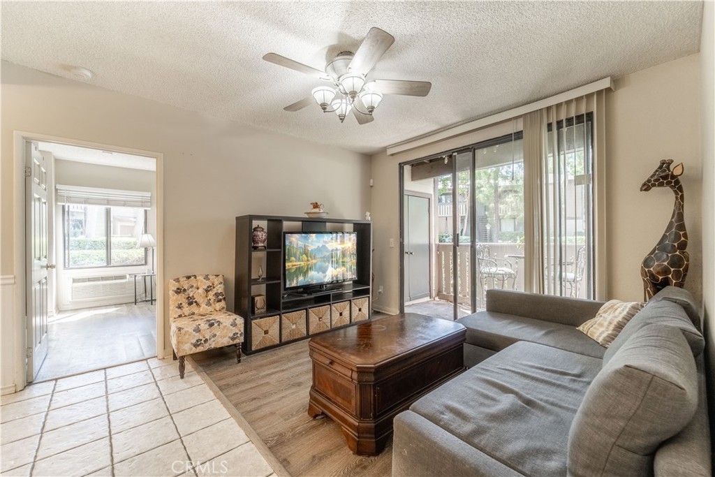 20702 El Toro Road, Unit 413 Lake Forest, CA 92630 - Photo 3 of 29 a living room with furniture and a flat screen tv