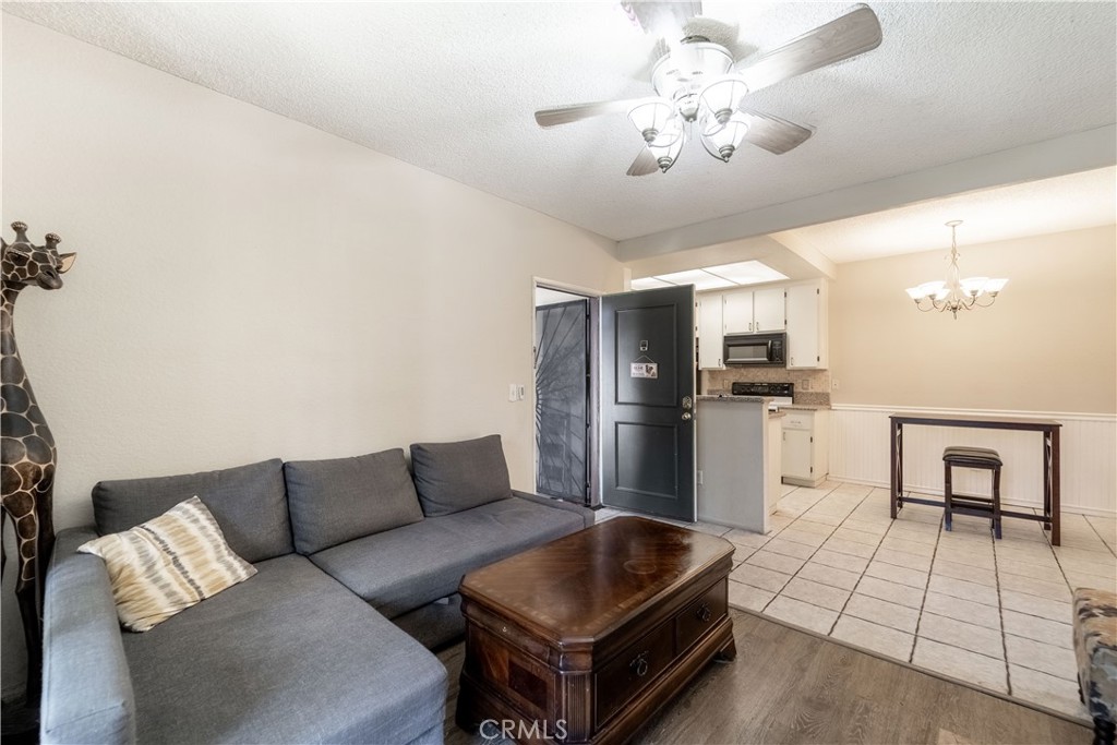 20702 El Toro Road, Unit 413 Lake Forest, CA 92630 - Photo 4 of 29 a living room with furniture and kitchen view