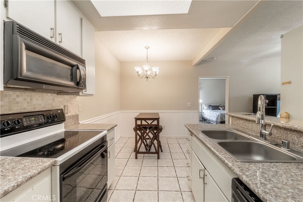 20702 El Toro Road, Unit 413 Lake Forest, CA 92630 - Photo 7 of 29 a kitchen with a sink stove and microwave