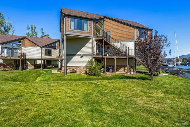 a view of a lush green field with mountains in the background