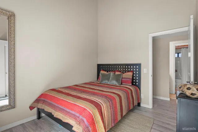 a bedroom with a bed and dresser