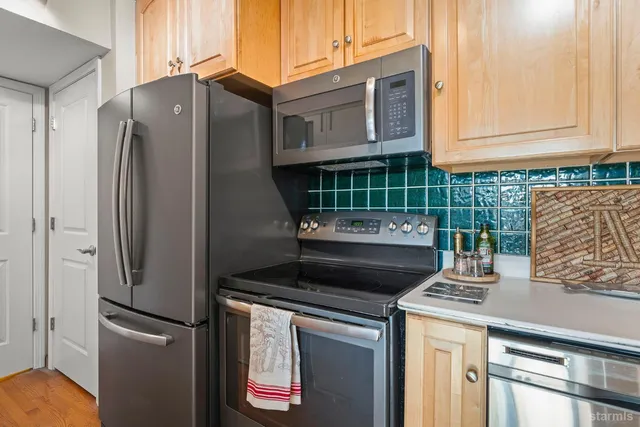 a kitchen with granite countertop a refrigerator and a stove